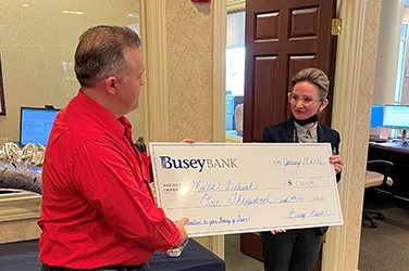 Busey associates presenting a donation check