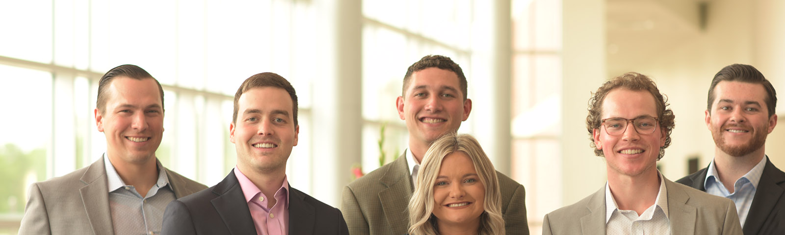 a group of young people smiling inside a building