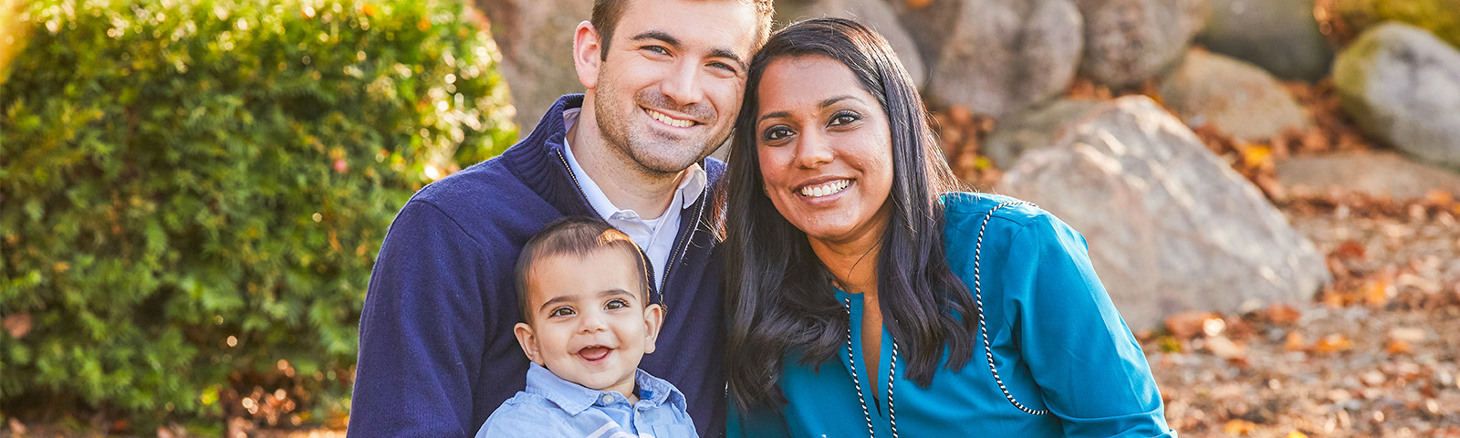 A young family is posing together for a picture