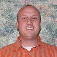 Busey associate Eric Evans smiling