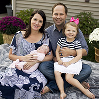 Busey associate Molly Chesna holding her baby while sitting with family