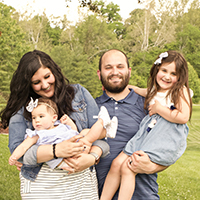 Busey associate Neena Frisch posing with her family.