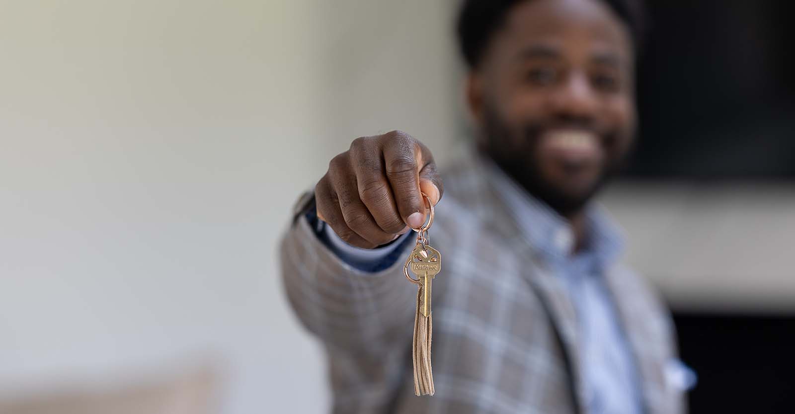 Busey Associate, Jeremy Thorpe, holding keys to new home.