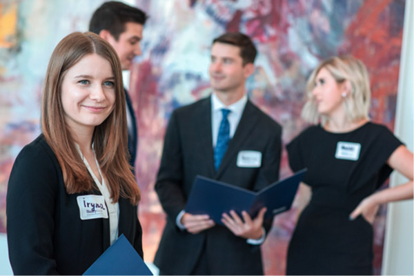 A young woman smiling amongst a crowd