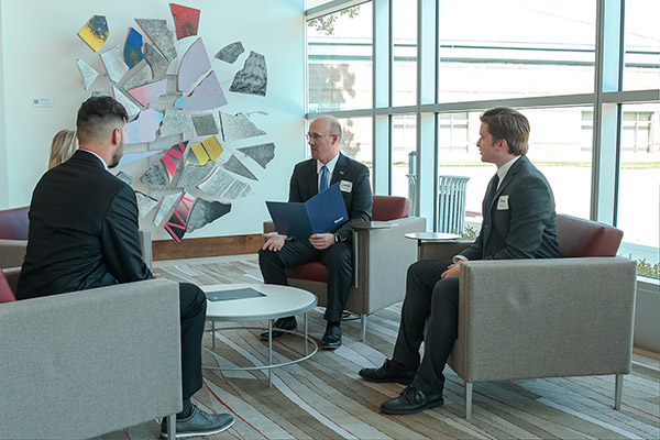 a group of men sitting and talking