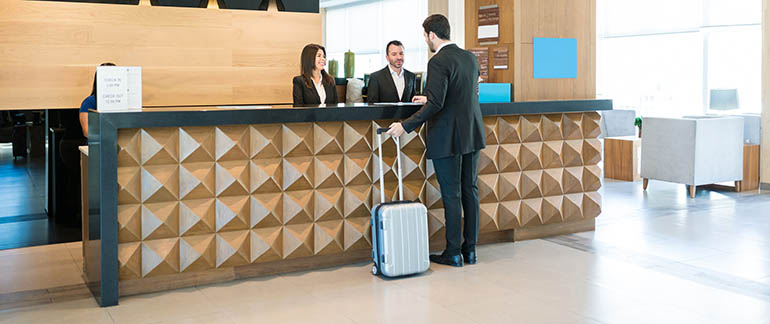 a man checking in at hotel counter