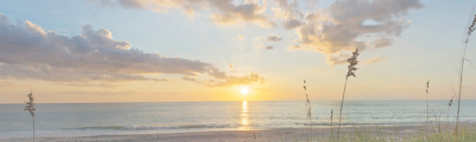 Sun rise over the ocean with a beach